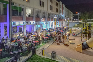 Night gathering with crowd in public plaza, vila pouca de aguiar, a Photo by DanFLCreativo
