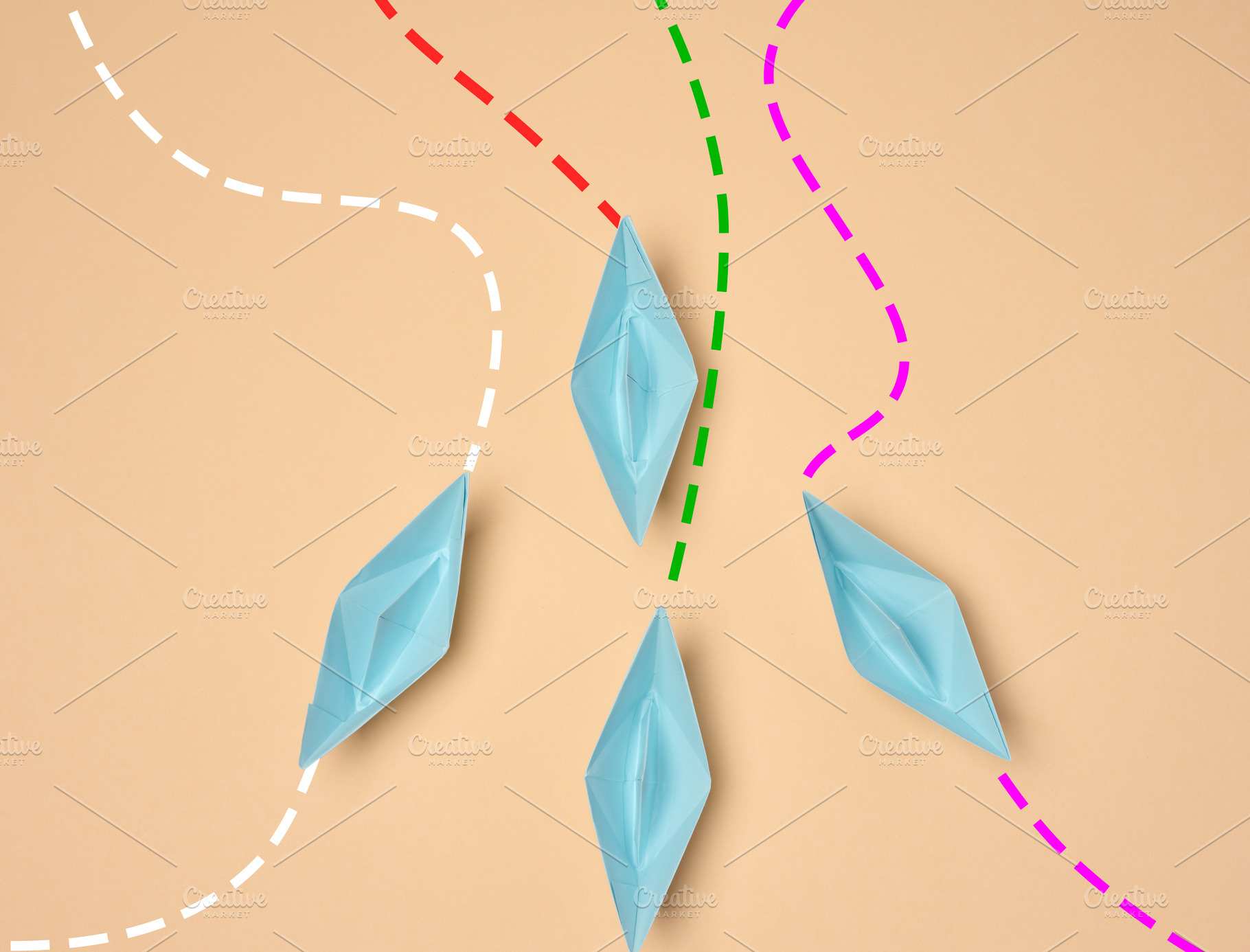 Top view of four blue paper boats following different dotted lin, a Business Photo by ndanko