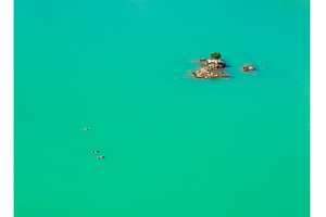 Three paddleboards float away from, a Nature Photo by Backyard Stock