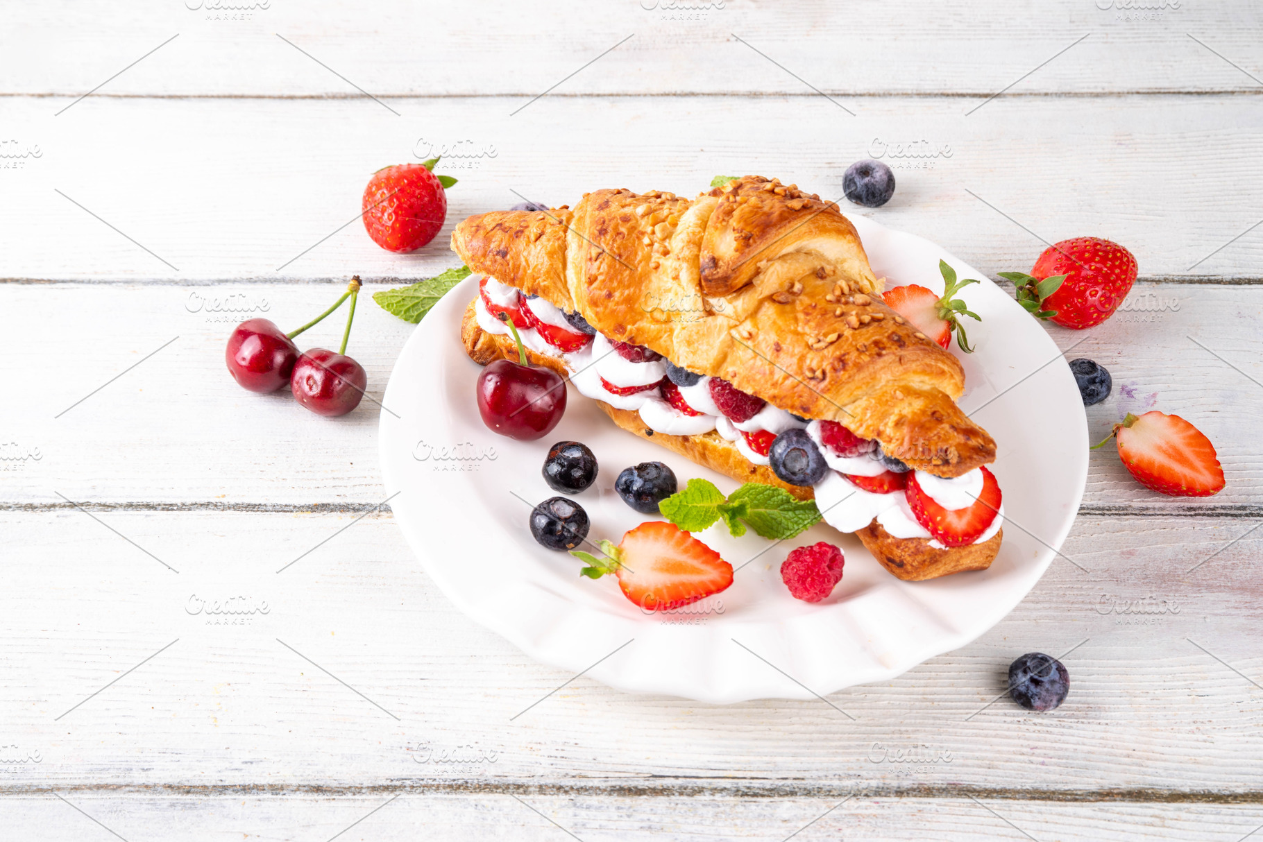 Sweet breakfast croissant sandwich with whipped cream, fresh fru, a Food & Drink Photo by Rimma