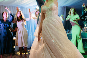 bride with bridesmaids dancing on dance floor in wedding, a Person Photo by Weddings, People, Travel