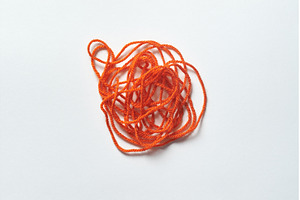 Red tangled thread on white., a Health & Medical Photo by Yaroslav Danylchenko