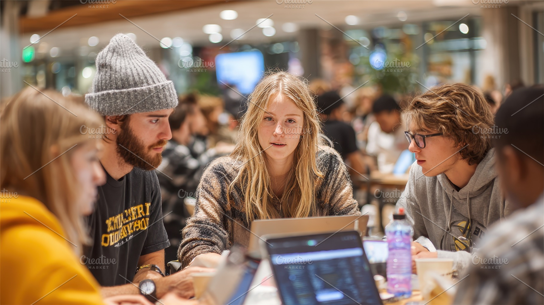 Young adults collaborate on laptops, a Photo by Pixeness Studio