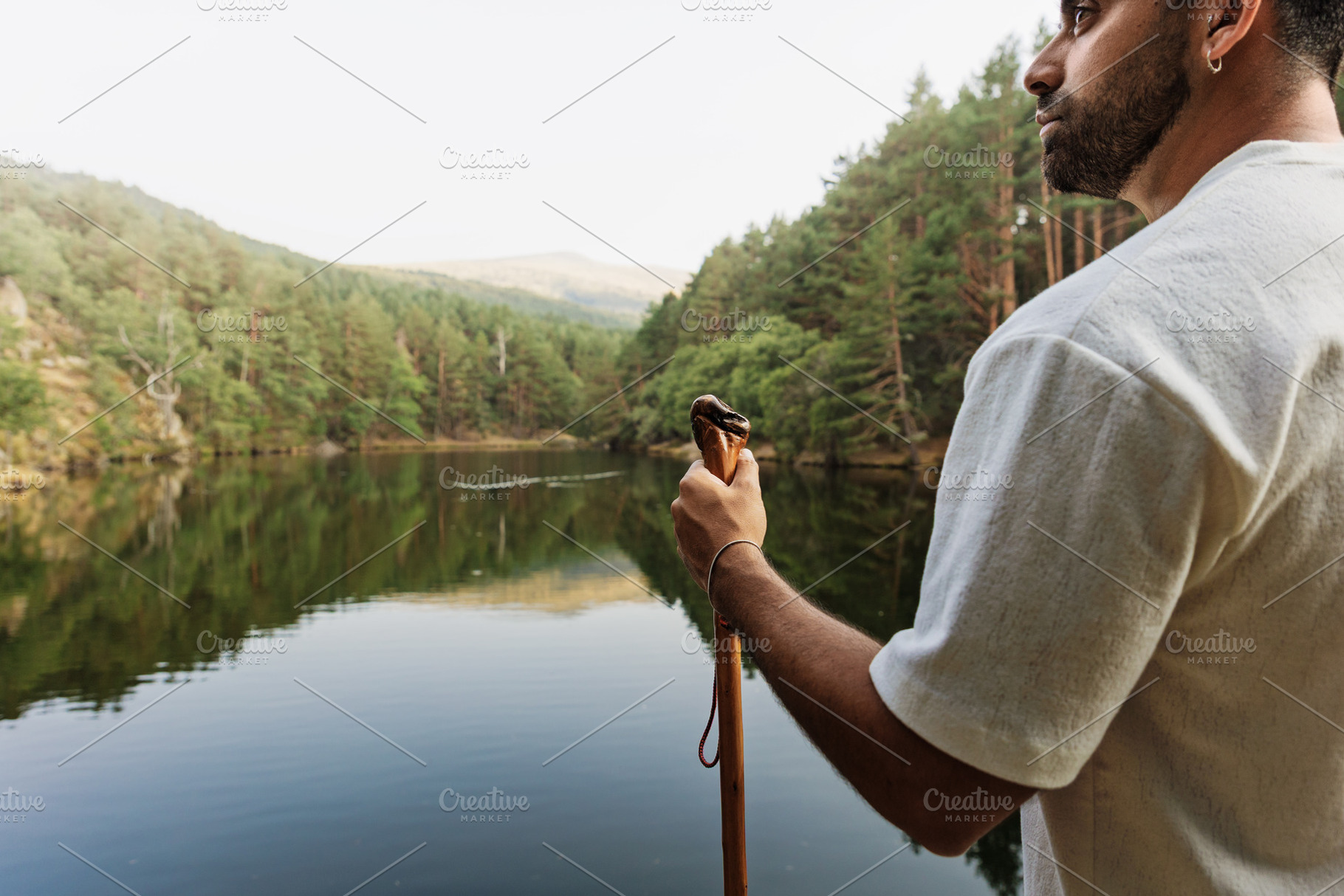 Man contemplating a lake in a mounta, a Person Photo by Perpis