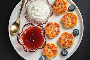 Cottage cheese pancakes, syrniki, curd fritters decorated with strawberry and r, a Food & Drink Photo by Budarinphoto