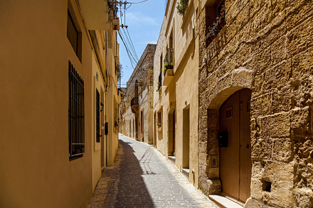 A narrow medieval street with stone stock photo containing flower and, an Architecture Photo by Photostock