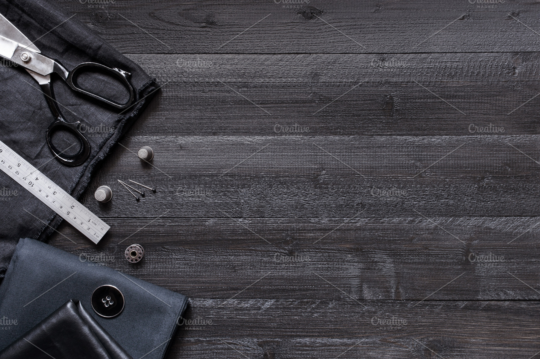 Black wooden sewing background featuring sewing, accessories, and tool, an Arts & Entertainment Photo by AlinaKho