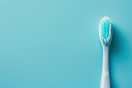 New toothbrush on blue background, a Health & Medical Photo by AlyaAnd