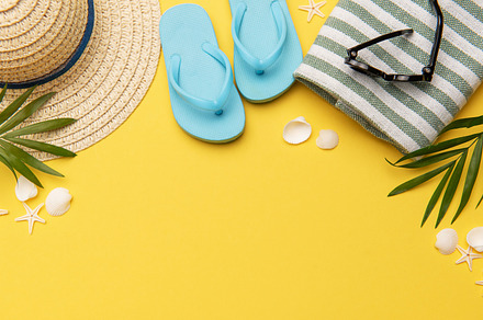 Summer holiday beach background with beach accessories and tropi