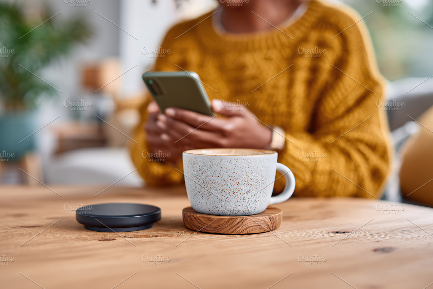 Warm cup of coffee sits on a wooden table as a person checks their phone in a c, a Photo by AlyaAnd