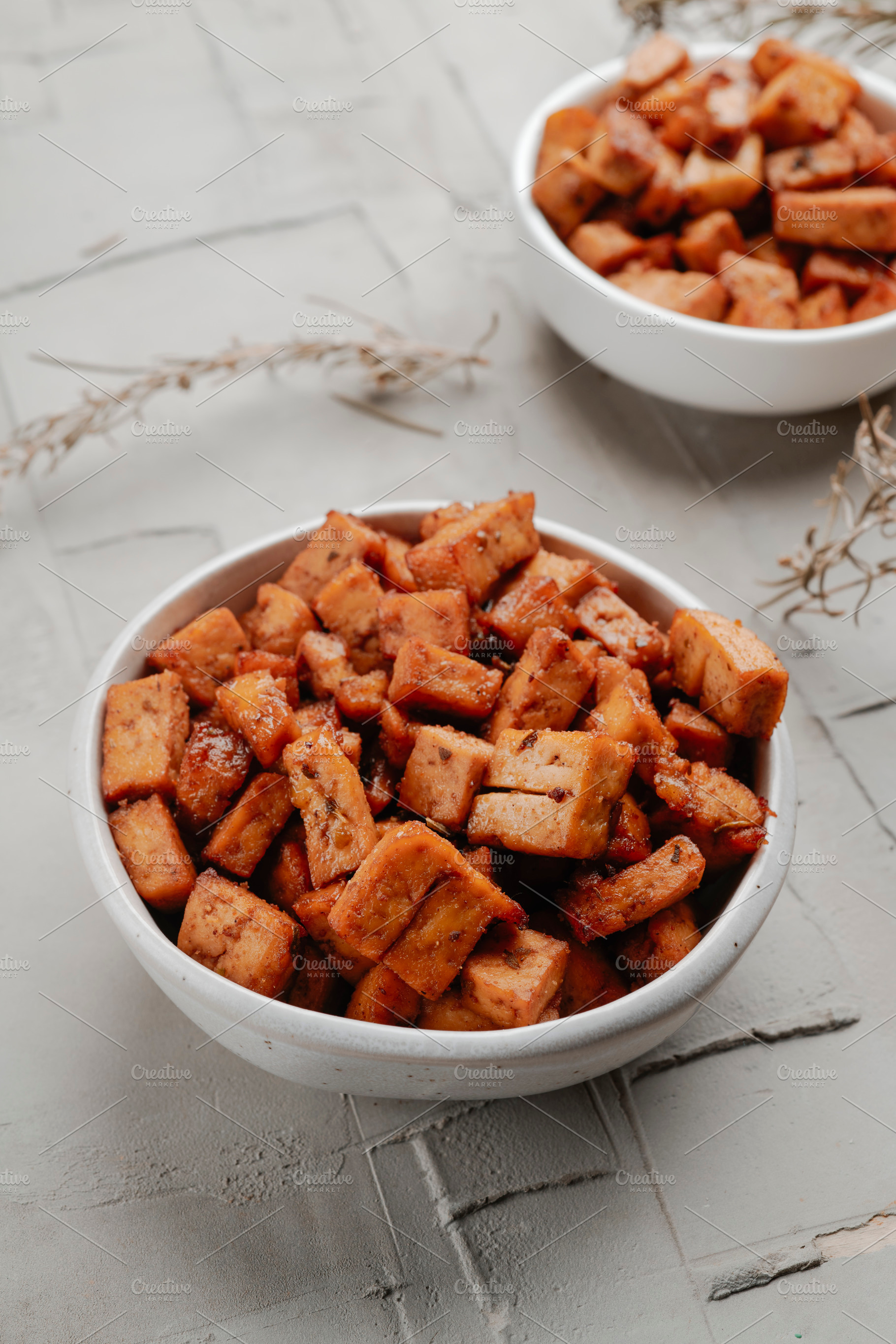 diced marinated tofu in a pair of white bowls, a Photo by Nito