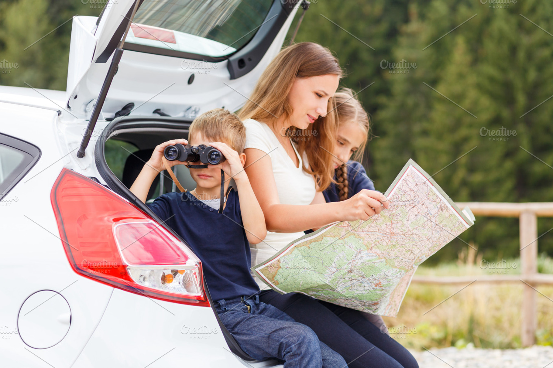 Family travelling by car and using map to navigate stock photo containing, a Person Photo by serkum