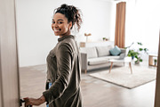 Cheerful Black Female Opening Entry Door Entering Apartment, a Photo by Prostock-Studio (Thumbnail 2 of 2)