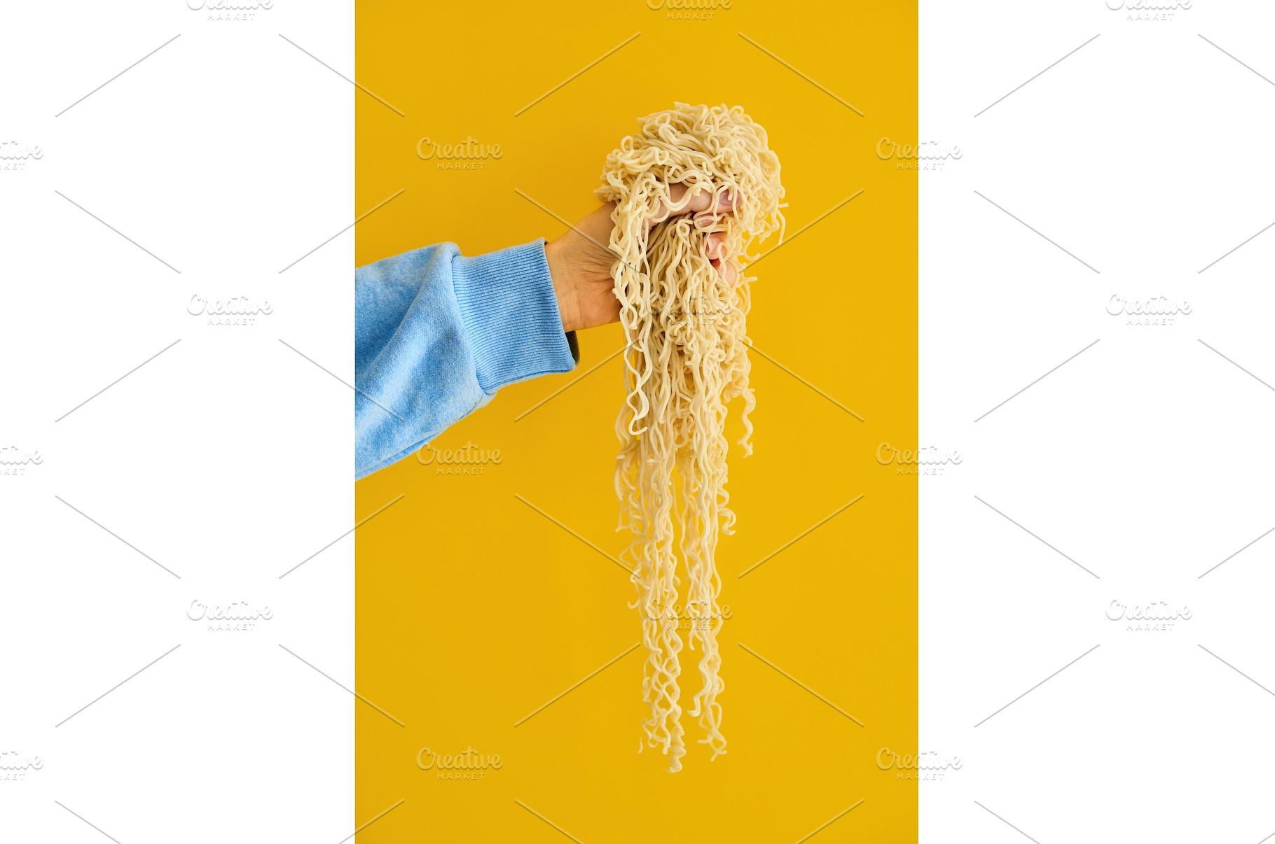Hand holding clump of long cooked, a Food & Drink Photo by Gladkov photography