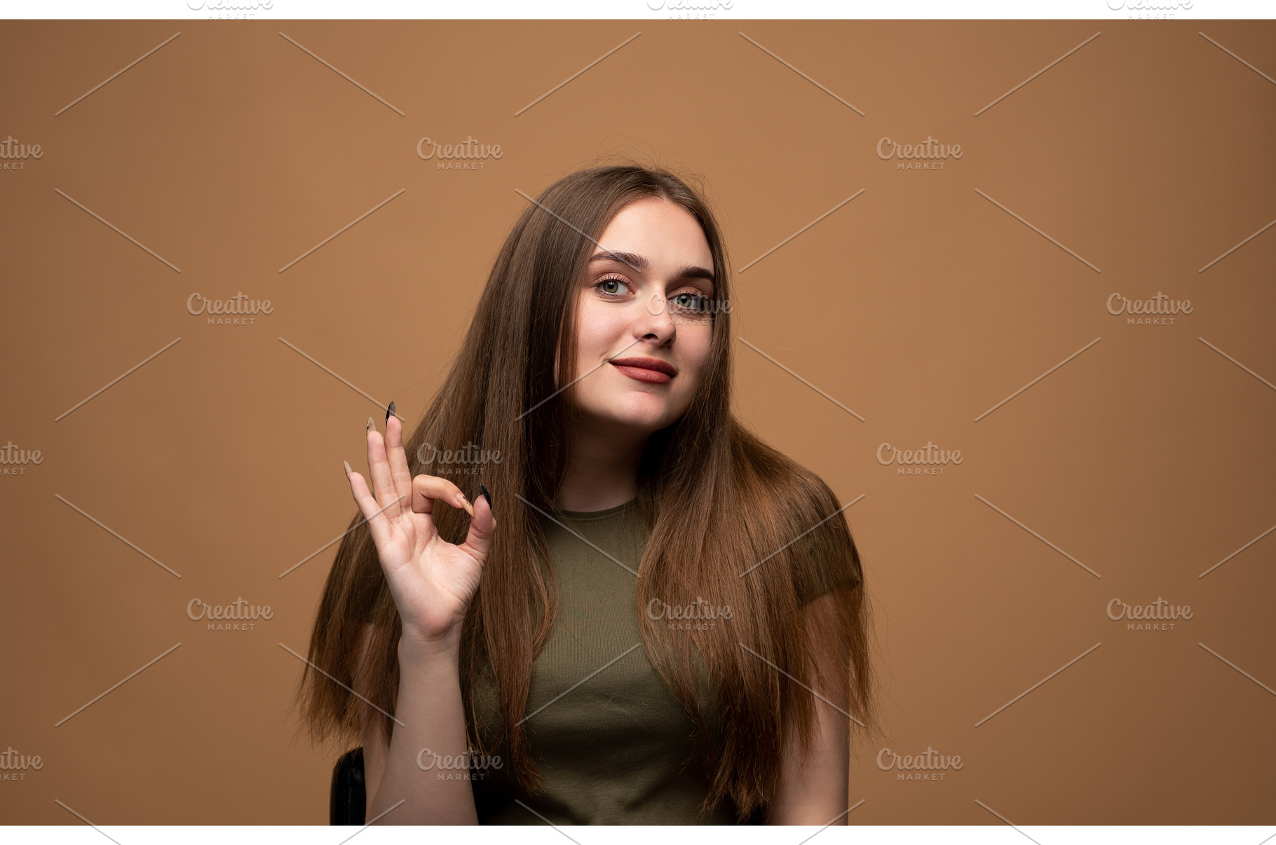 Young woman showing okay gesture, a Person Photo by volodymyrshtun13795