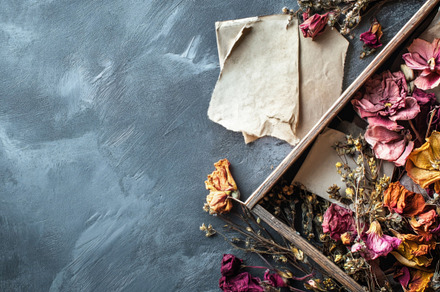 Wooden box filled with dried flowers on gray textured surface., an Abstract Photo by Natalia Klenova's Shop