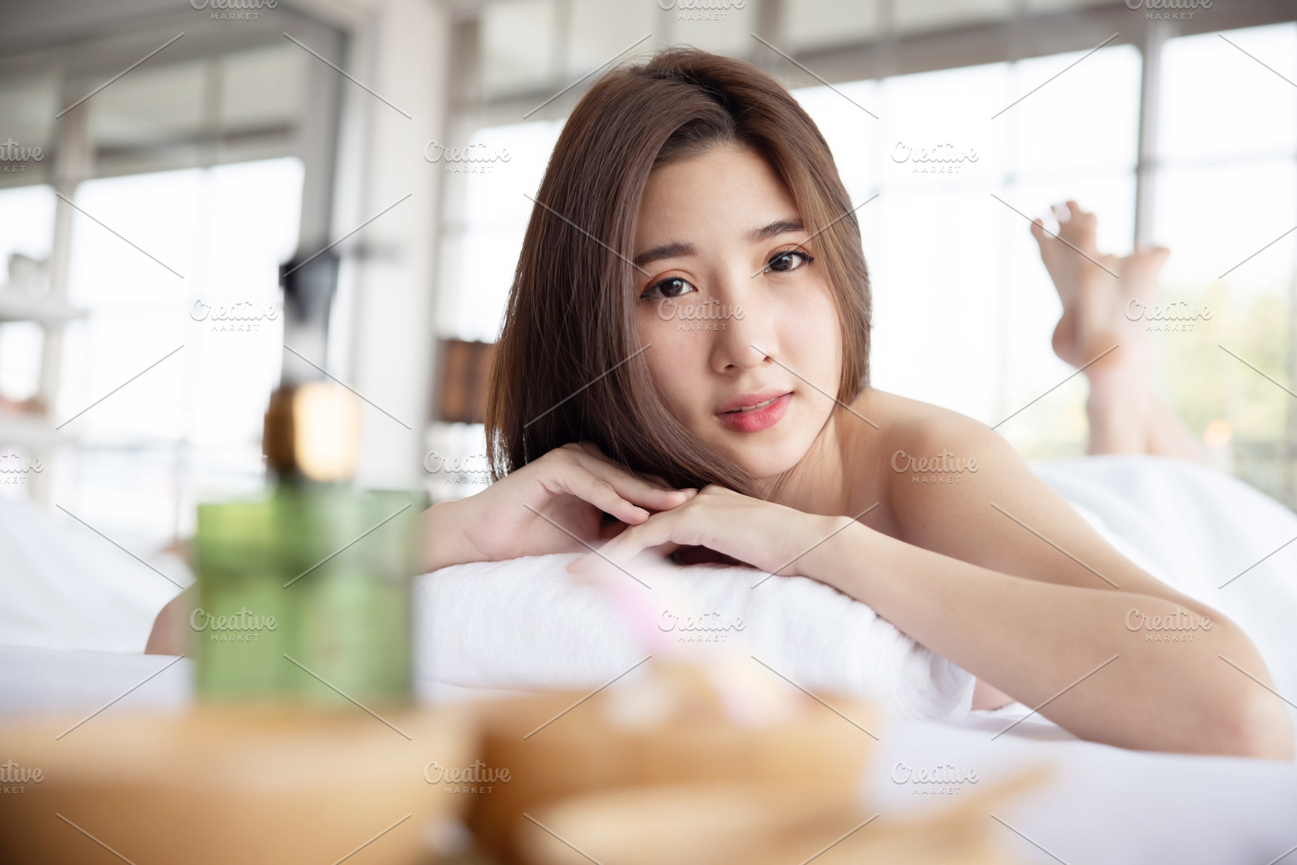 Woman Lying Down on Massage Bed, a Health & Medical Photo by charnsitr