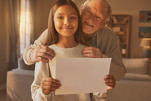 Older person with younger person holding blank paper, a Photo by DanFLCreativo