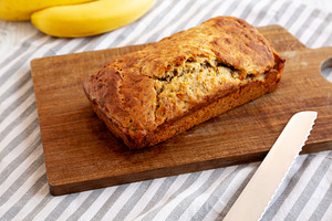 Homemade Banana Bread on a wooden board, side view., a Food & Drink Photo by LiudmylaChuhunova