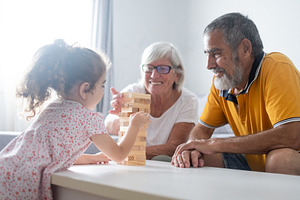Grandparents and granddaughter playing at home, a Person Photo by etorres69