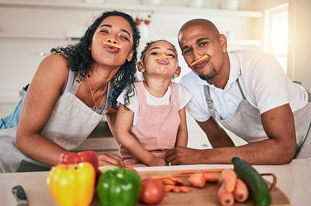 Food, vegetables and portrait of girl with parents together for learning, child development and bonding in kitchen. Family home, cooking and mom, dad and child smile in meal prep for healthy lunch, a Photo by Peopleimages.com