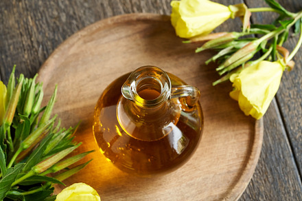 A bottle of evening primrose oil with fresh blooming evening pri, a Photo by Madeleine Steinbach