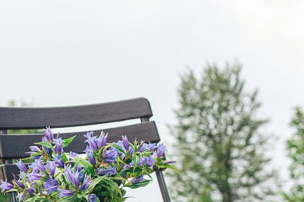 Cup of coffee on the chair over mountains landscape, a Person Photo by travnikovstudio