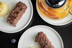 Delicious glazed curd snacks with fresh blueberries and mint on light grey tabl, a Food & Drink Photo by Budarinphoto