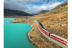 Aerial view of red train near alpine, a Transportation Photo by den-belitsky