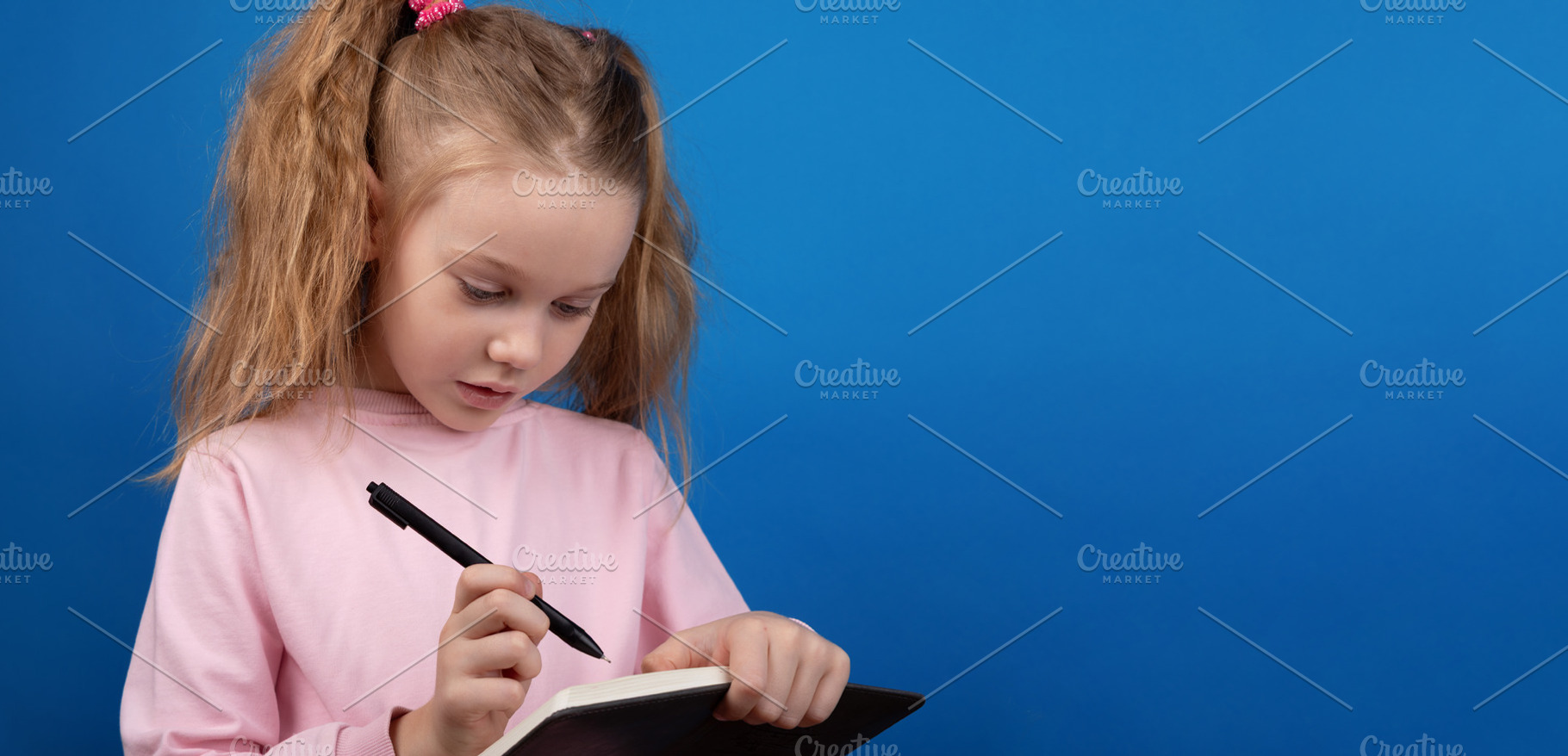 Child Writing in Notebook, a Person Photo by Ales Munt
