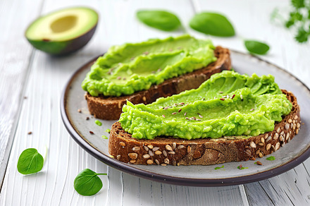 Toast breads with avocado puree on wooden table. Vegetarian food., a Food & Drink Photo by AlyaAnd