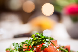 Fresh tomato and arugula salad served in a luxury hotel restaura, a Food & Drink Photo by Studio ANNA