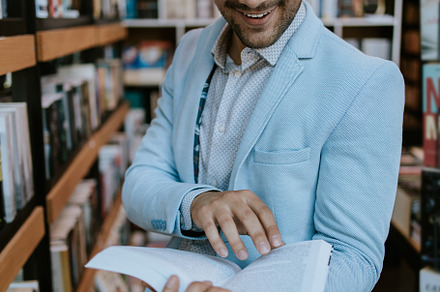 Young man in library, a School & Education Photo by REDDOT Studio