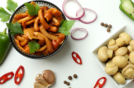 Bowls of marinated mushrooms on white background, a Food & Drink Photo by AtlasStudio PRO