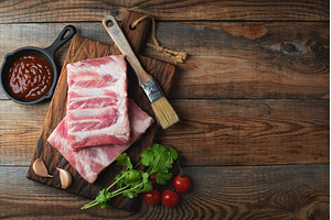 Raw pork ribs with spices, salt and, a Food & Drink Photo by Budarinphoto