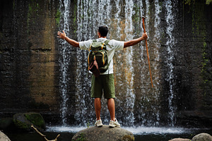 Man with backpack in front of waterf, a Person Photo by Perpis