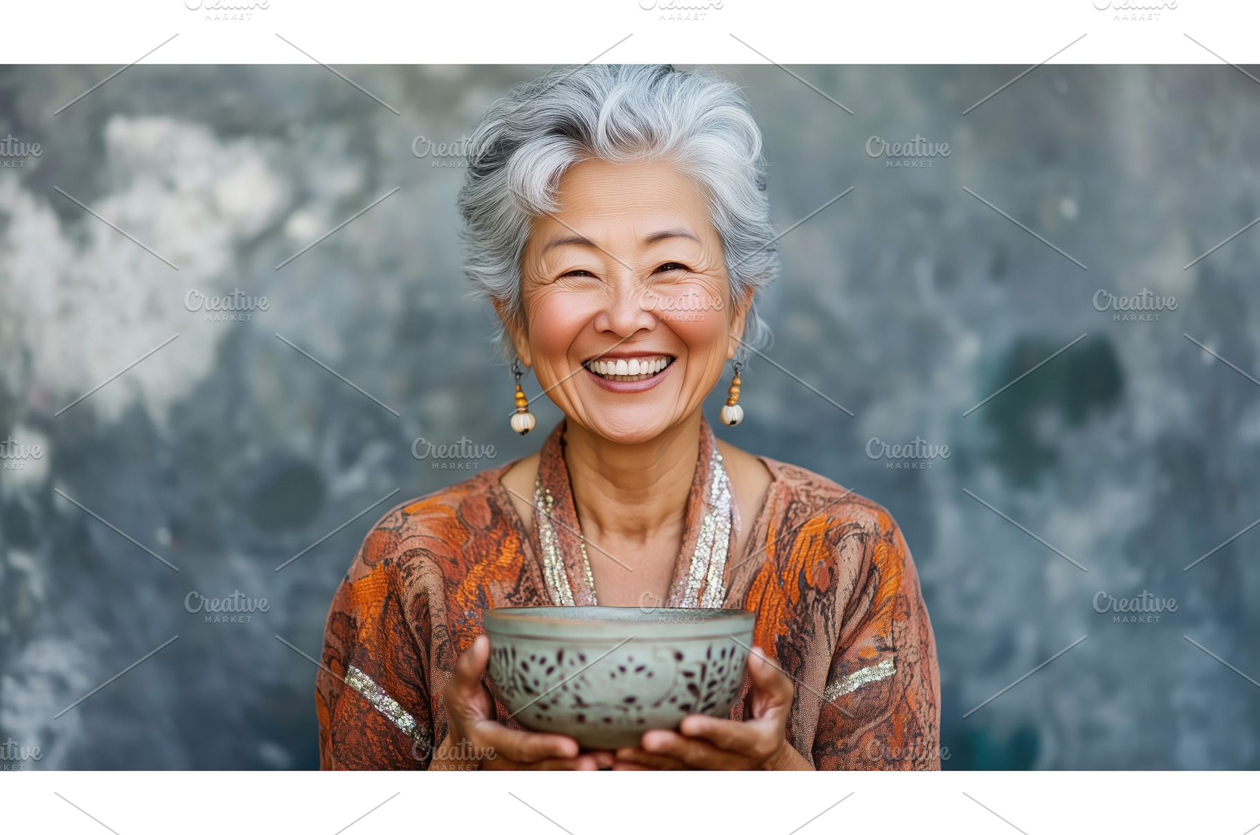A joyful Asian senior woman holding, a Person Photo by Sergey Kotenev