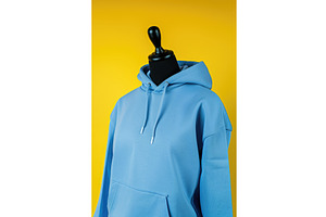 A blue hoodie on a mannequin on a, an Illustration by tilialucida