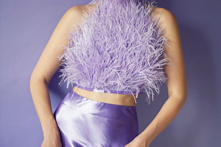 portrait woman in an evening purple dress with feathers stands in the backgroun, a Person Photo by SaulichPhoto