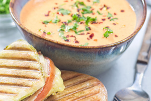 Red bell pepper cream soup served with grilled turkey panini, vertical, a Food & Drink Photo by iuliia_n