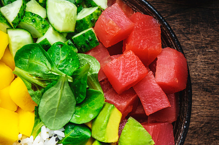 Poke bowl with fresh tuna, avocado, mango, cucumber, lettuce and, a Food & Drink Photo by 5PH