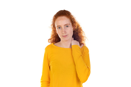 Young redhead woman suffering of backache, touching her shoulder, a Person Photo by José Manuel Gelpi