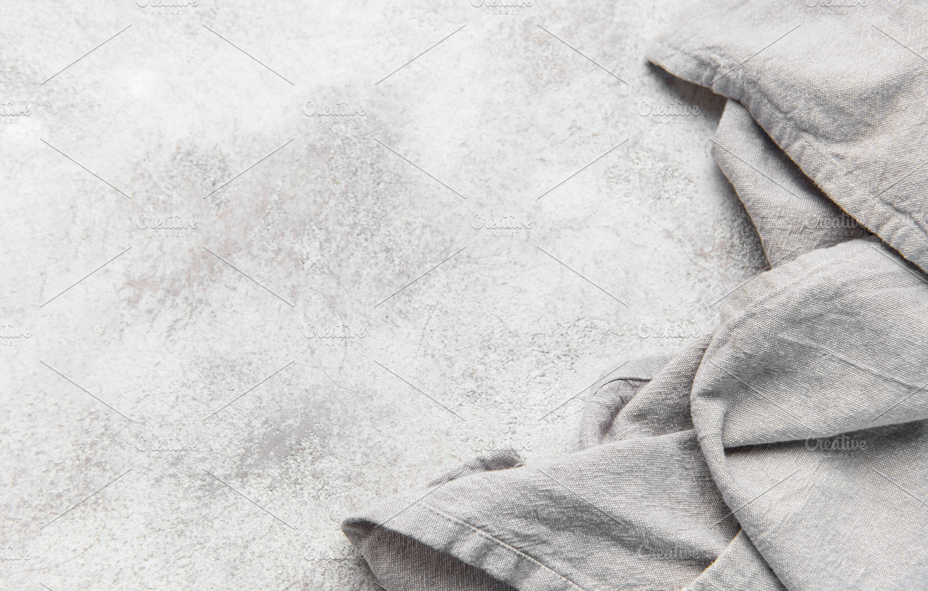 Gray kitchen textile on textured grunge counter background, a Food & Drink Photo by Olena Rudo