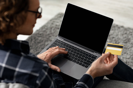 Man Using Laptop And Credit Card Shopping Online Indoor, Back-View, a Background Photo by Prostock-Studio