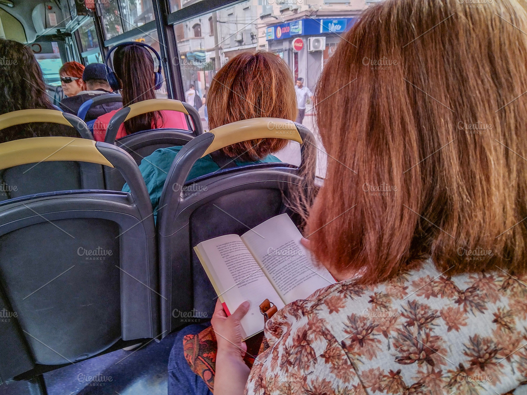 View from inside a bus looking over a passenger's shoulder, a Transportation Photo by DanFLCreativo