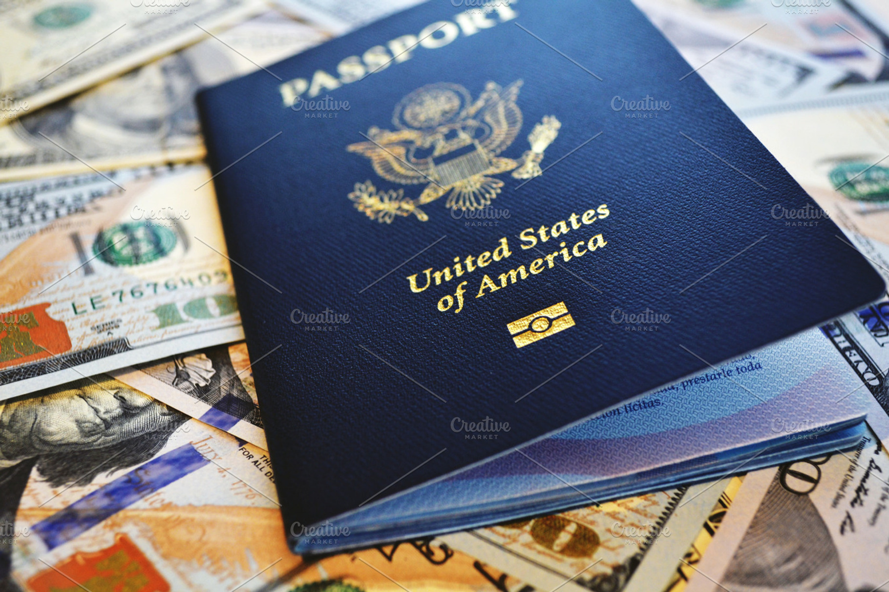 Passport containing united states, hundred-dollar, and bill
