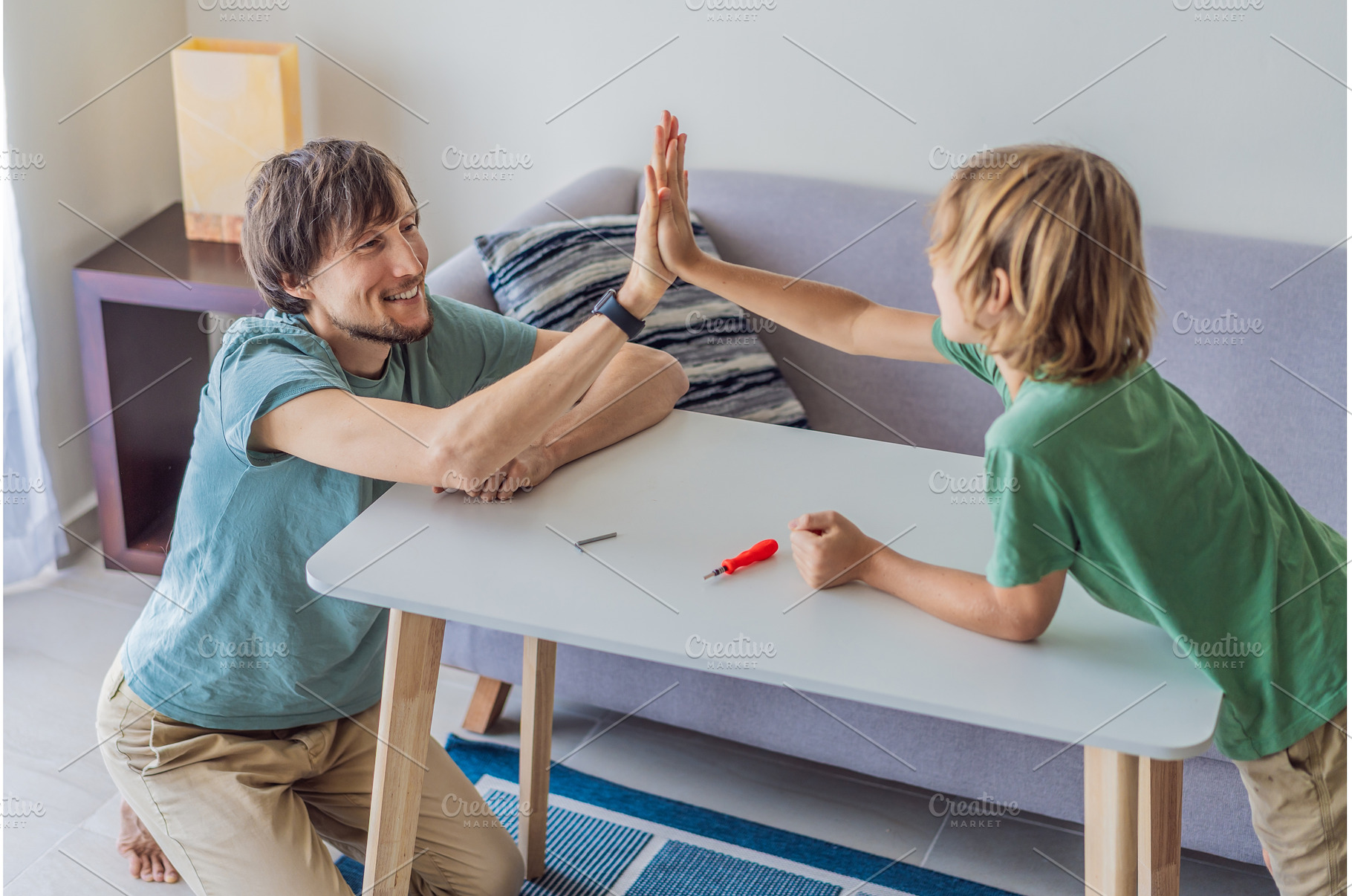 Father and his son assembling a, a Person Photo by Elizaveta Galitskaya