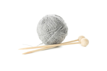 Knitting needles and yarn ball isolated on white background, a Beauty & Fashion Photo by AtlasStudio