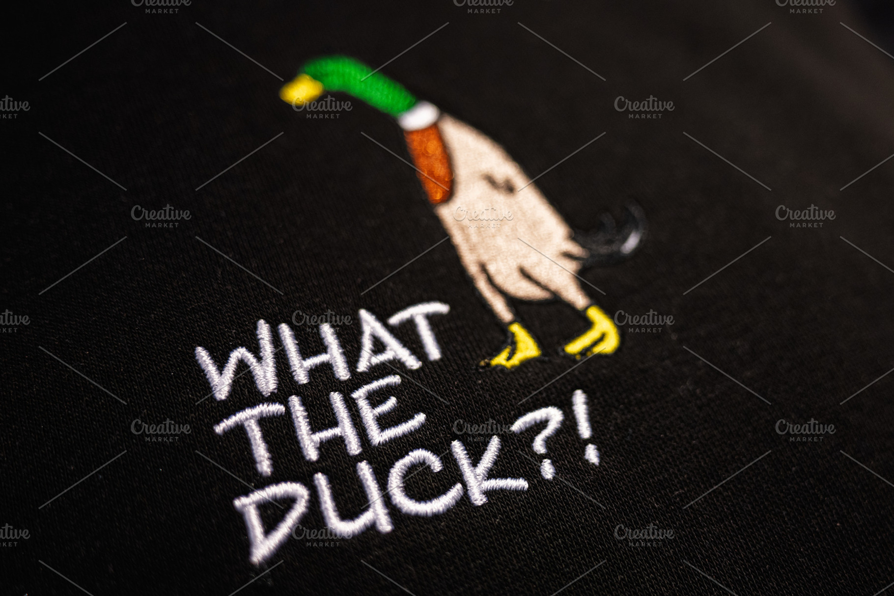 Colorful Embroidery of Duck on Black Fabric with Humorous Text, What the Duck?!, a Photo by AS photostudio