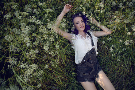 portrait of a teenage girl with purple hair and an earring in her nose lying in, a Person Photo by SaulichPhoto